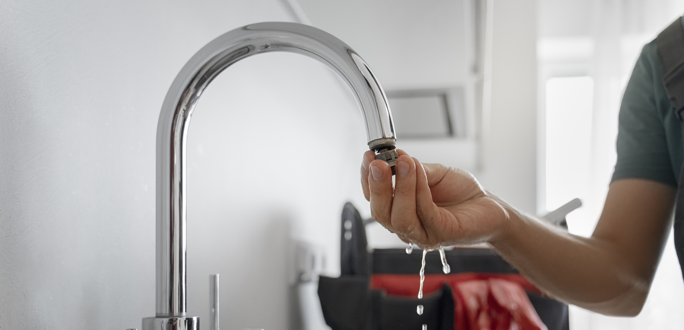 Individual installing an aerator on their sink 